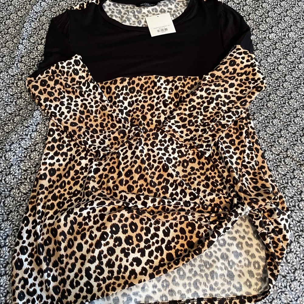 Buttery soft cheetah print top with twist at hip